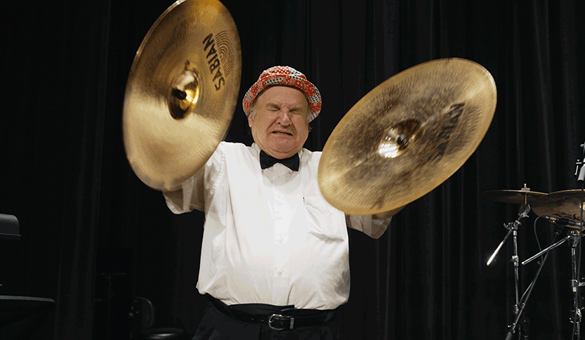 Uncle Floyd plays the cymbals at Glen Rock High School in the Banded Together documentary