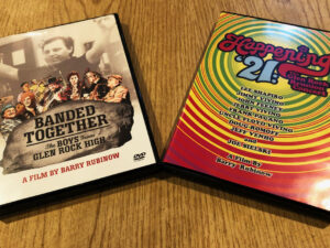 DVDs of Banded Together: The Boys From Glen Rock High and Happening '21: The Glen Rock Reunion Concert on a table